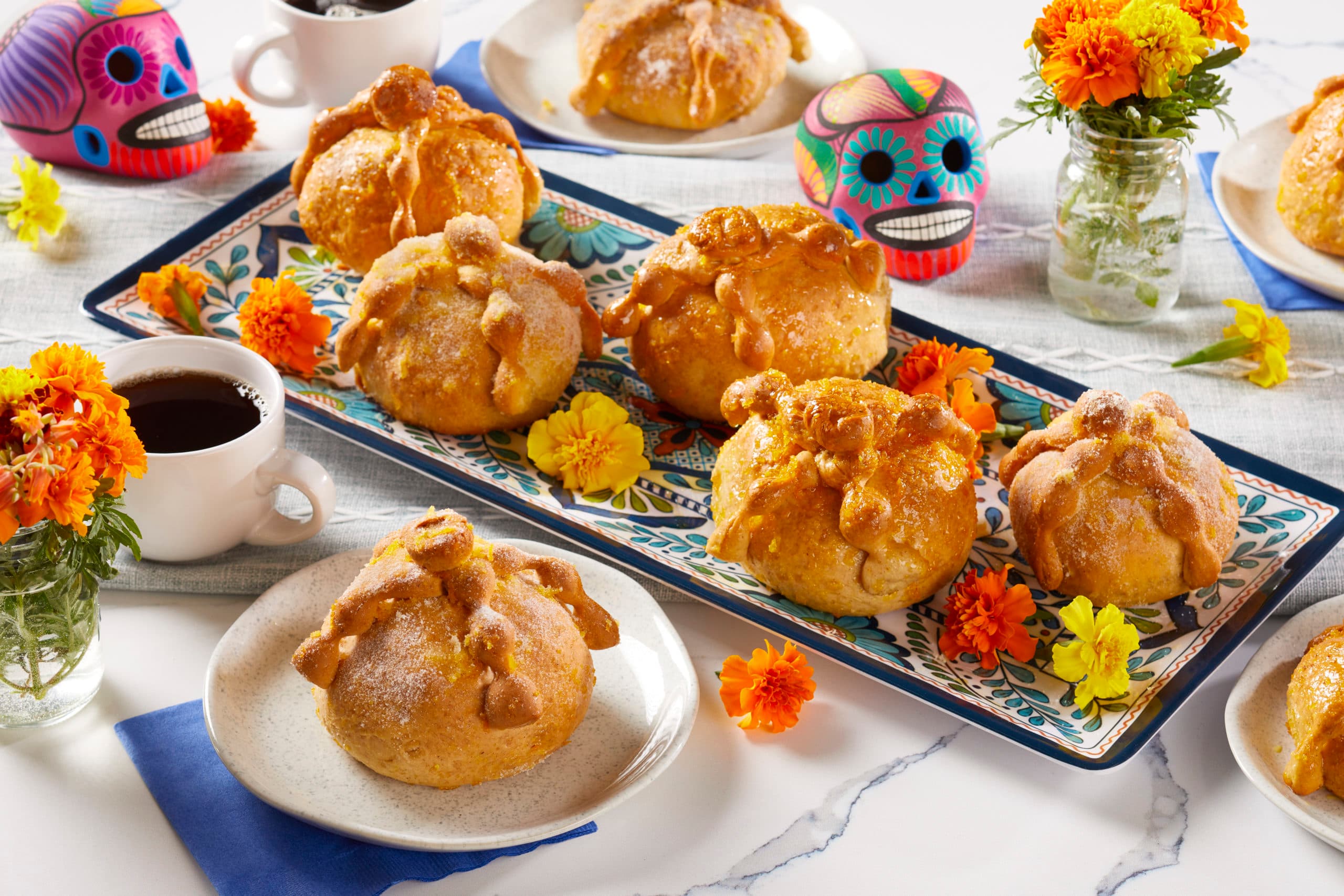 Cacique food and heritage celebration with pan de muerto and marigolds